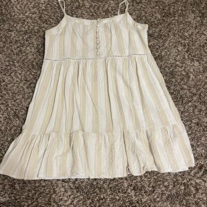 This tan and white striped dress is from the brand “mi ami” and size youth XL